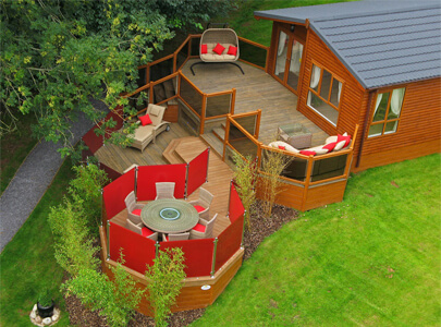 AB Sundecks Decking, Steel Red Glass and Picket Glass with an array of tables, chairs and a sunbed