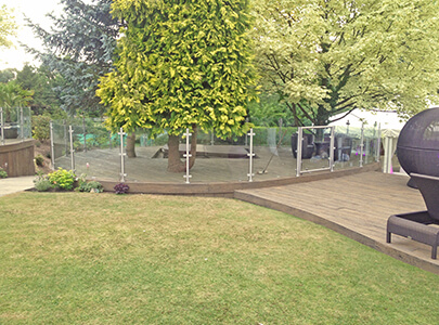 AB Sundecks Decking and Picket Glass in garden surrounding trees with Hot Tub in center